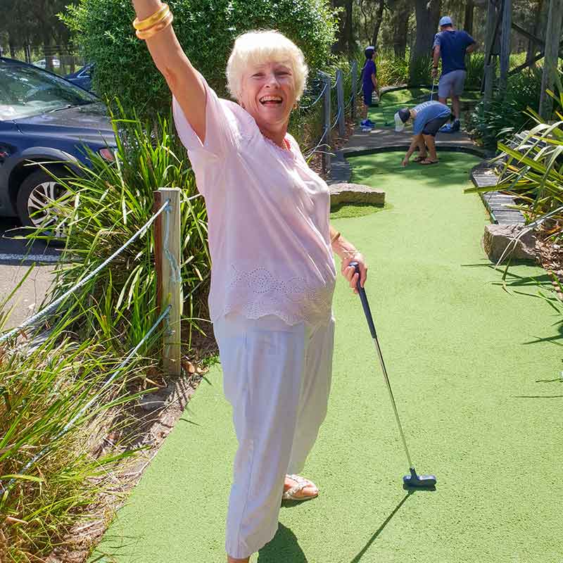 Senior Lady Playing Mini Golf at Pittwater Golf Centre