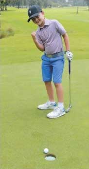 Jack Castle - Junior Golfer at Pittwater Golf Centre - On the green celebrating hit putt about to fall into the hole